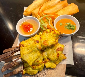 Chicken satay and Thai starters with dipping sauces